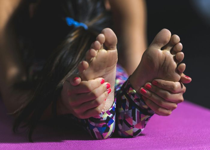 Close up of yoga practitioner during deep stretching